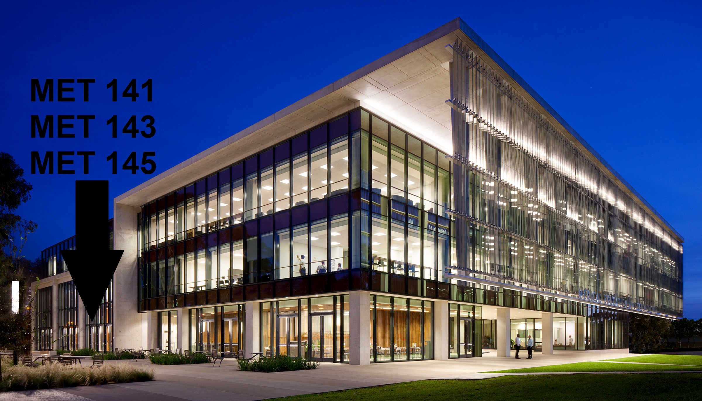 Photo of the MET building on the UC San Diego Health campus, with an arrow directing students to the side entrance of the building, used to get to MET 141-145.